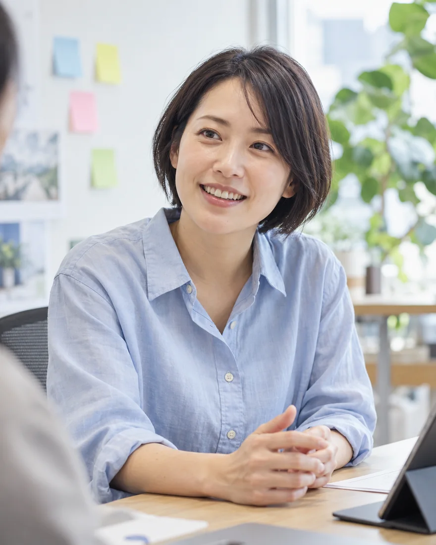 笑顔で仕事について話すデザイナーのイメージ